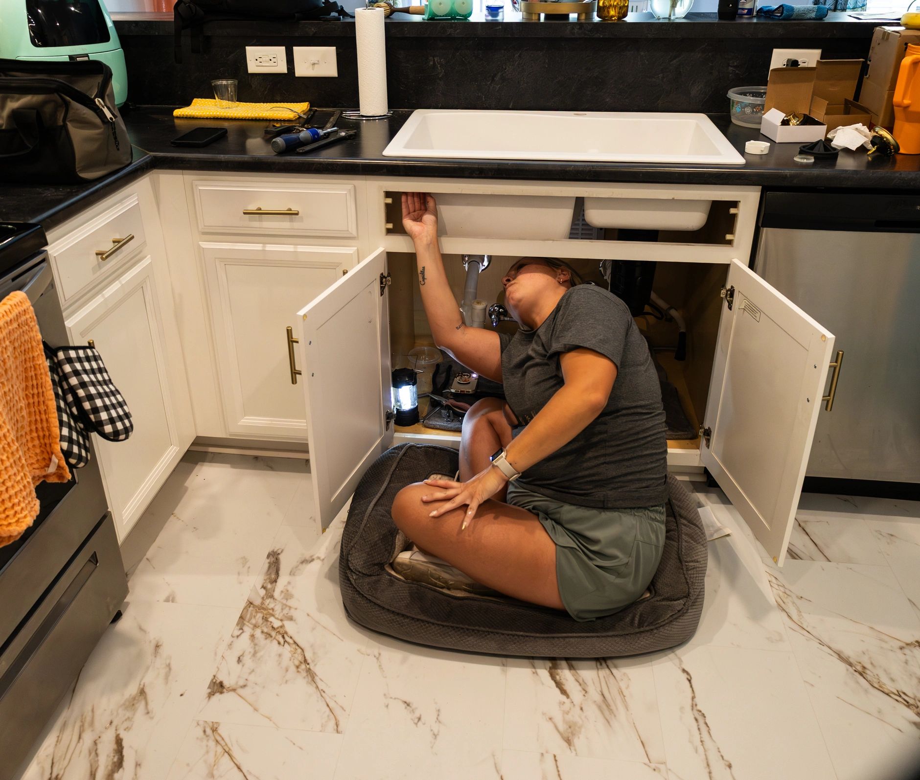 Plumbing repair under a kitchen sink